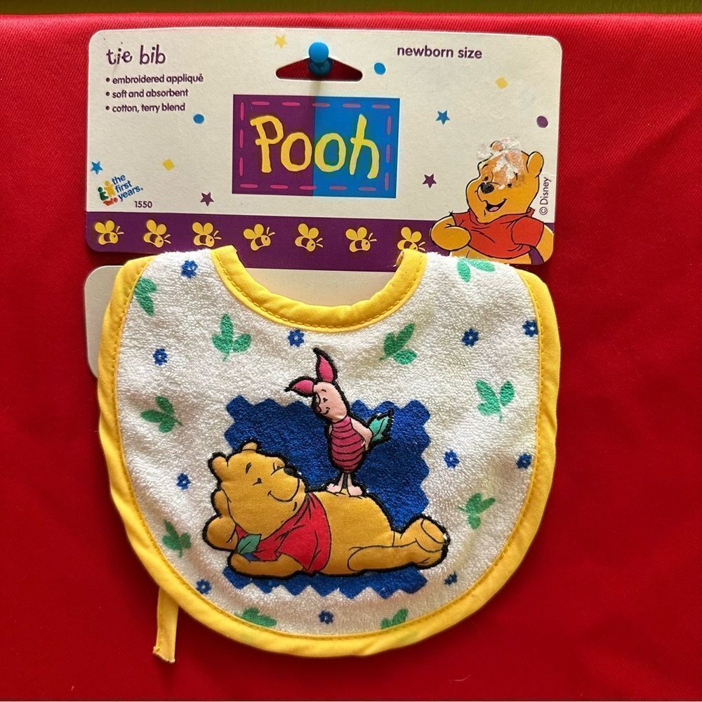 The first years Pooh Tie Bib Newborn